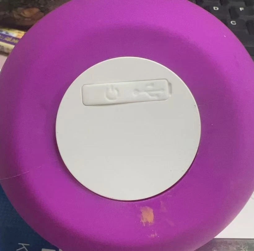The base of the indoor ambient light, showing the white cover plate, the embossed power button and the USB Type-C charging port.