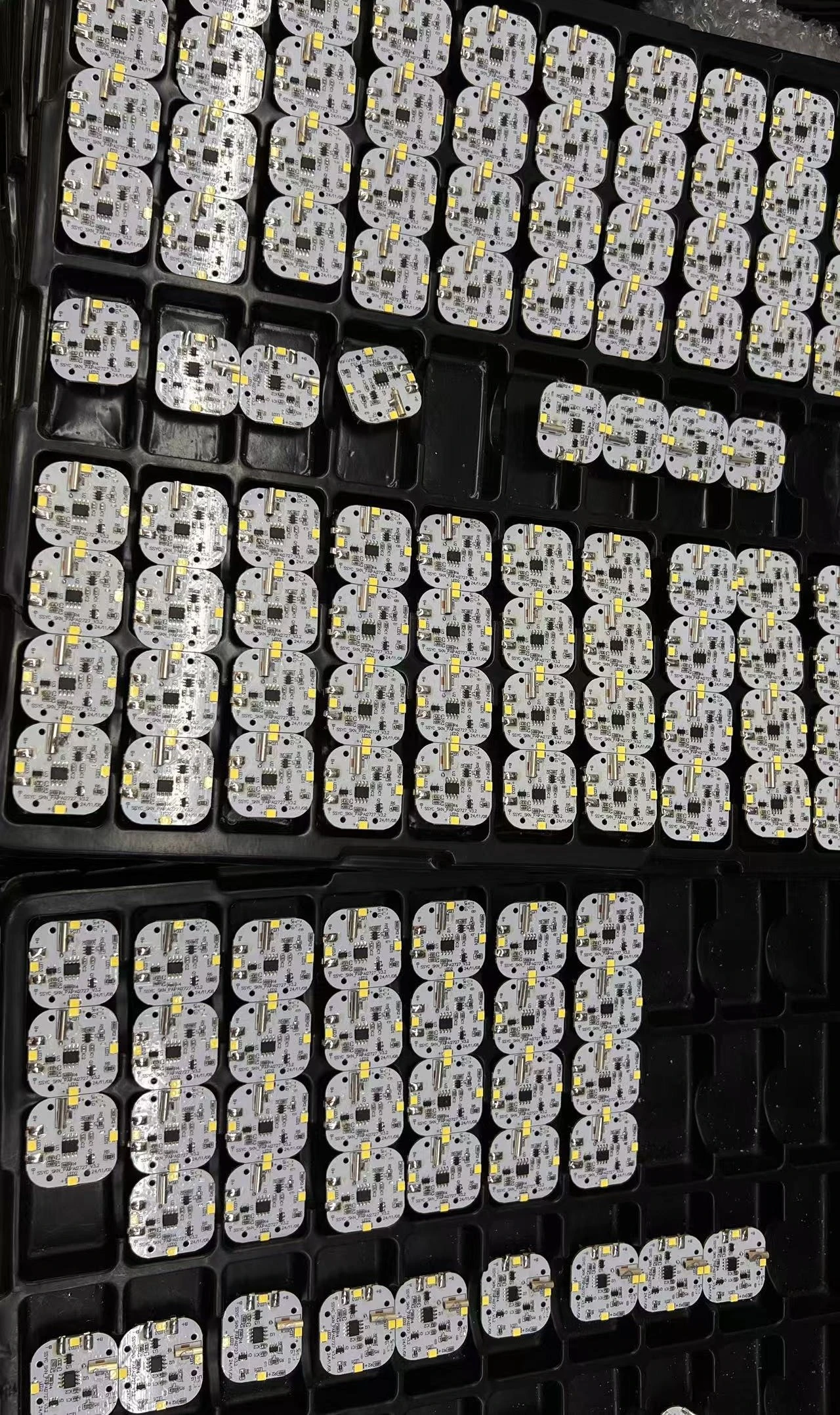 Assembled indoor ambient light boards in production trays, populated with LEDs, ICs and USB Type-C receptacles.