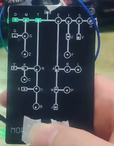 The front panel of the Morse code learning device, with the Morse tree on it and the LEDs lit.
